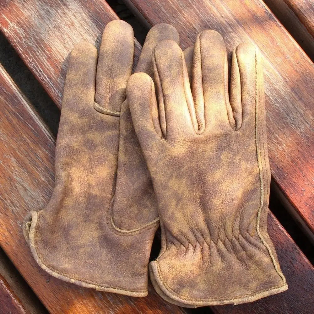 Pair of Vanefield tie-dye leather gloves on a wooden bench