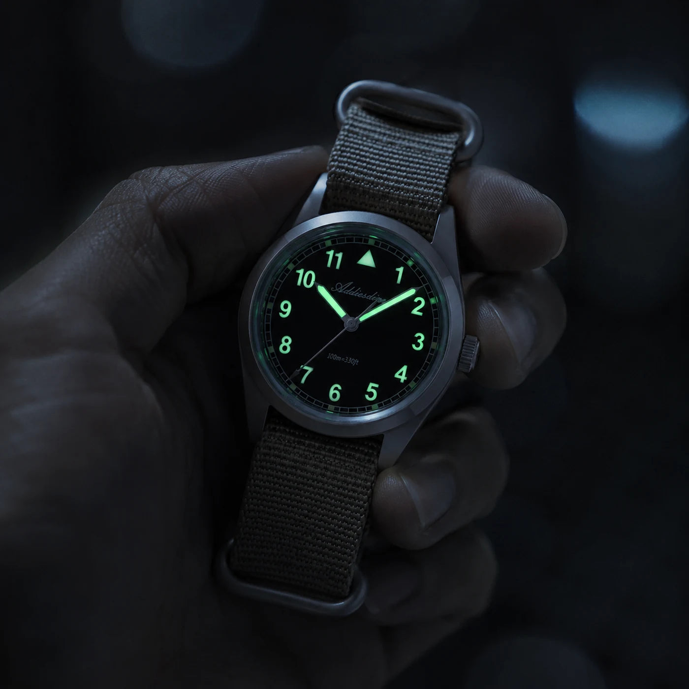 Dial of the Vanefield Field Watch 38 with green lume in the dark