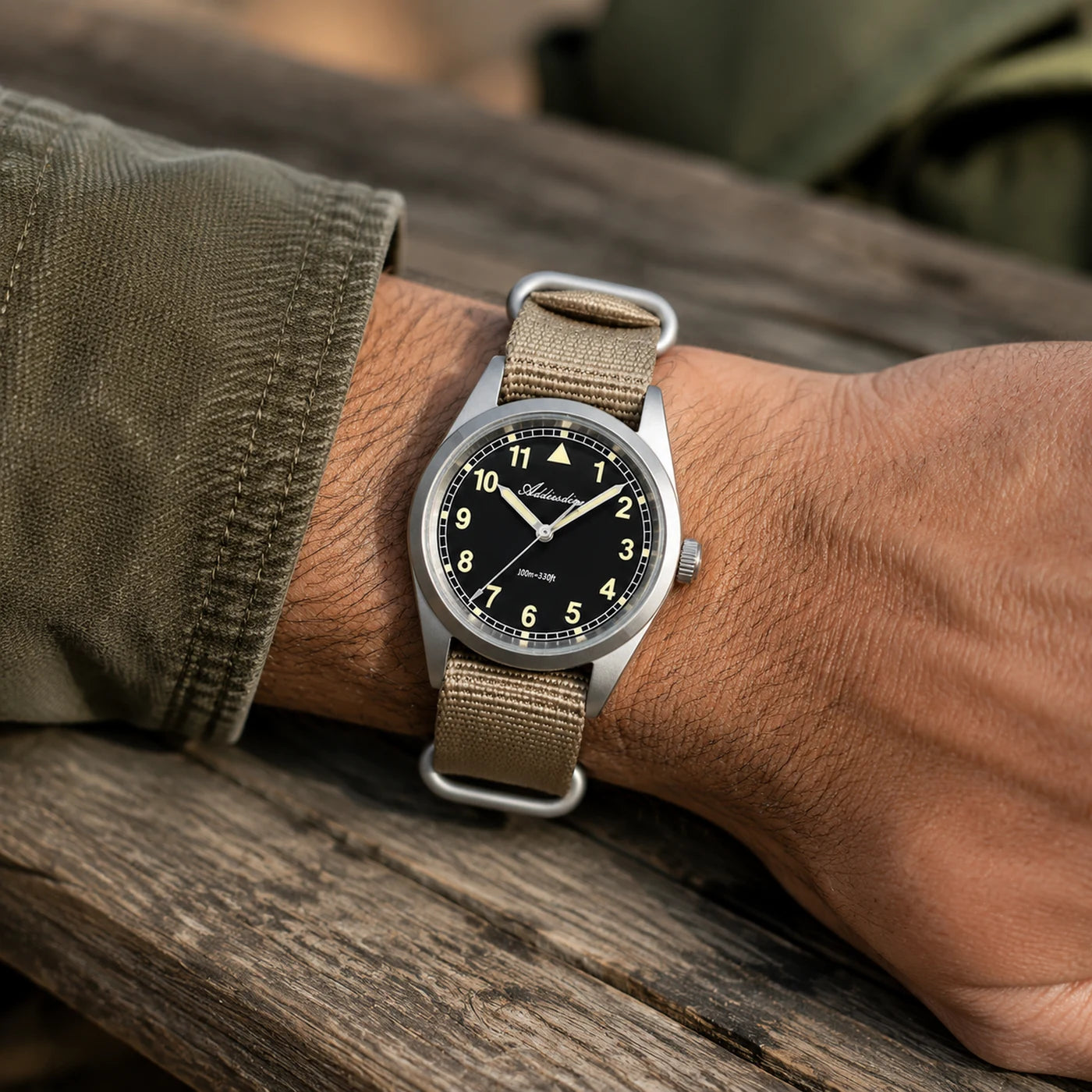 Vanefield Field Watch 38 on the wrist, resting on wood