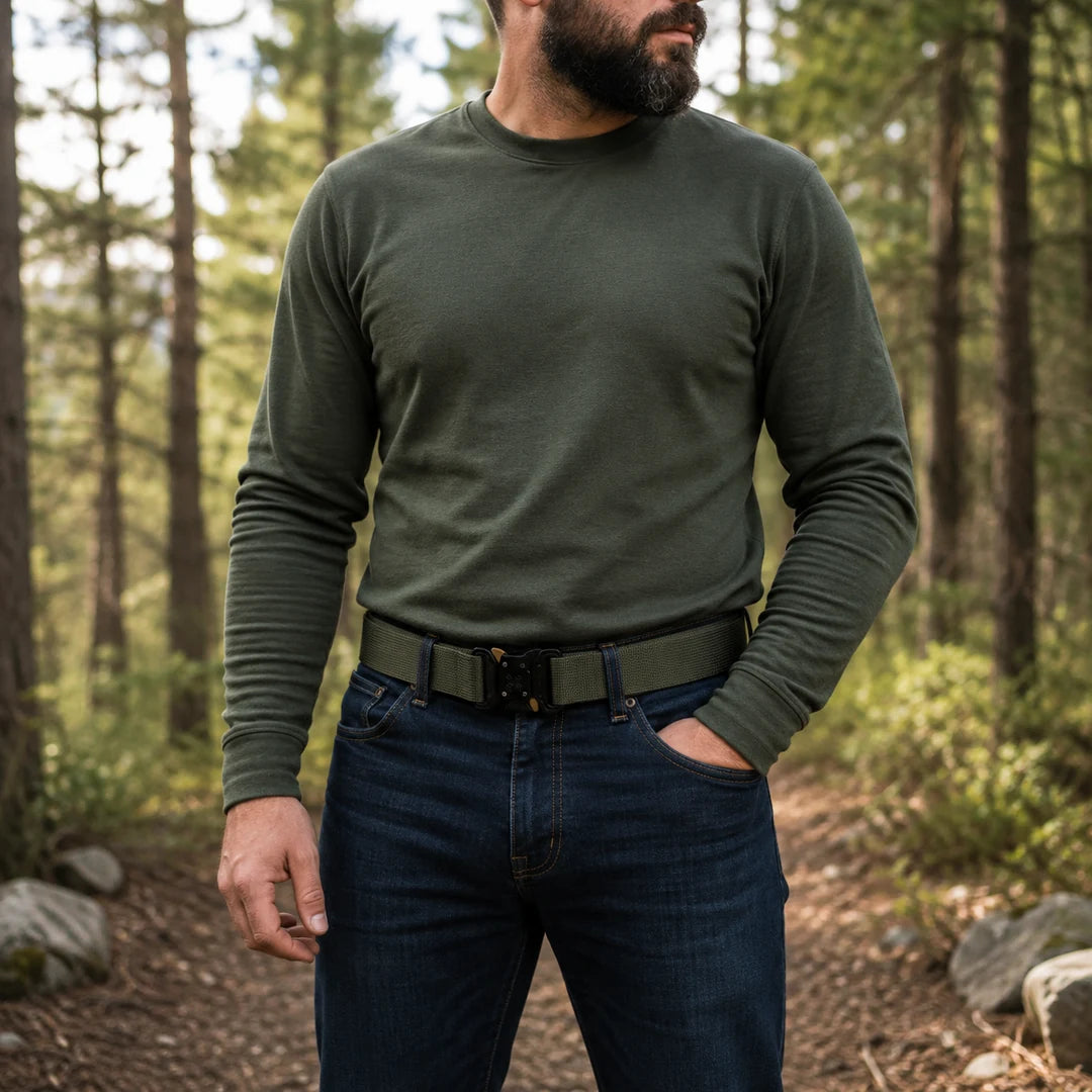 Man on a forest trail wearing the Vanefield tactical belt in black