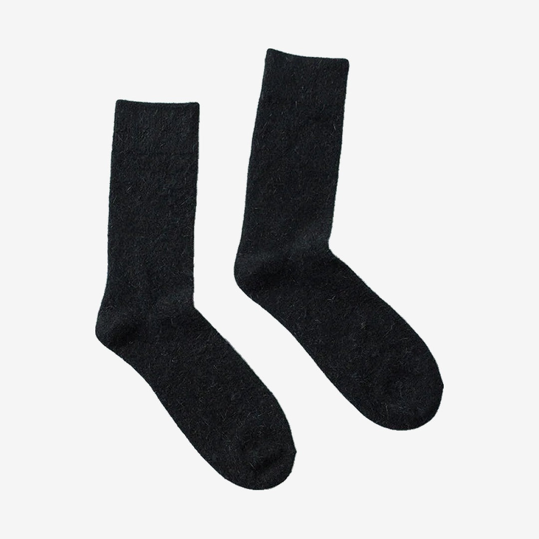 Vanefield knitted merino wool socks in black, pair standing