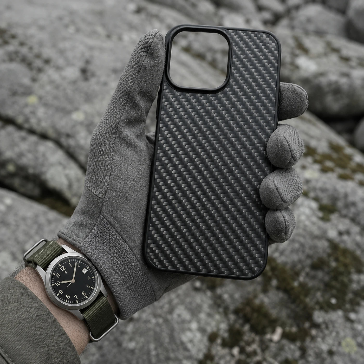 Gloved hand holding a phone in the Vanefield CarbonArmor Case outdoors