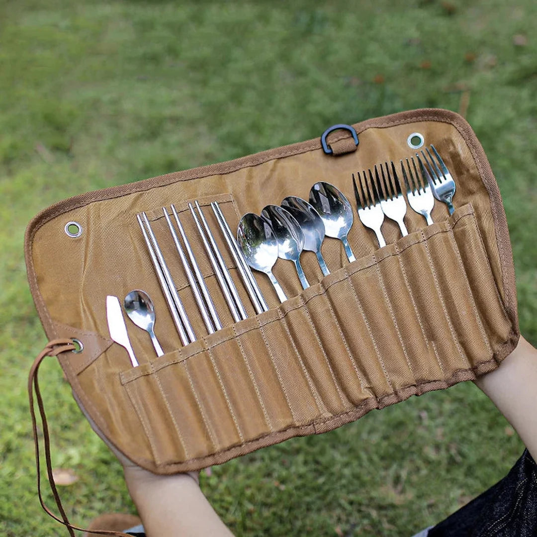 Cutlery roll open on the lap outdoors, full stainless set in view