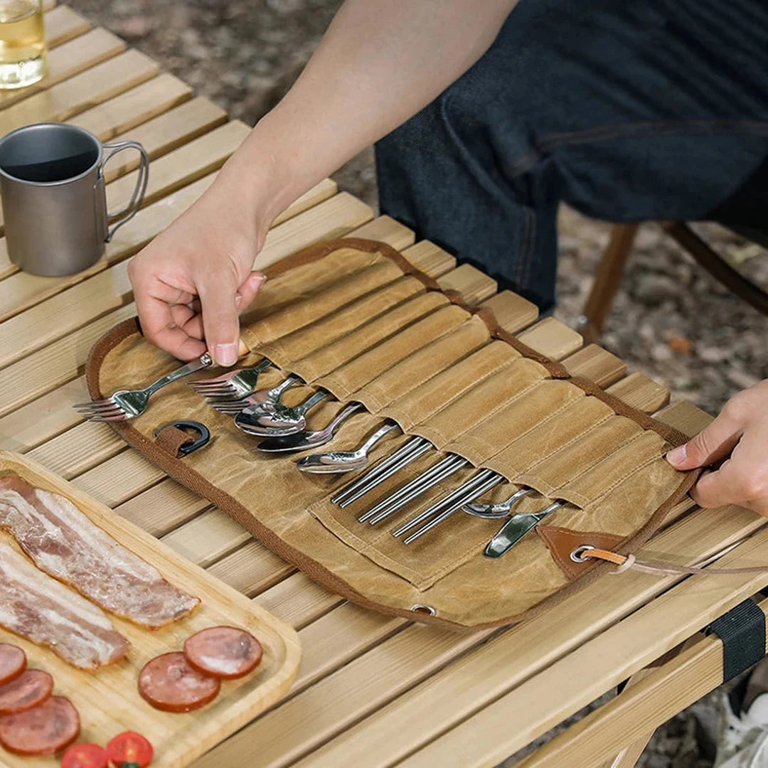 Stainless cutlery laid out on the open canvas roll